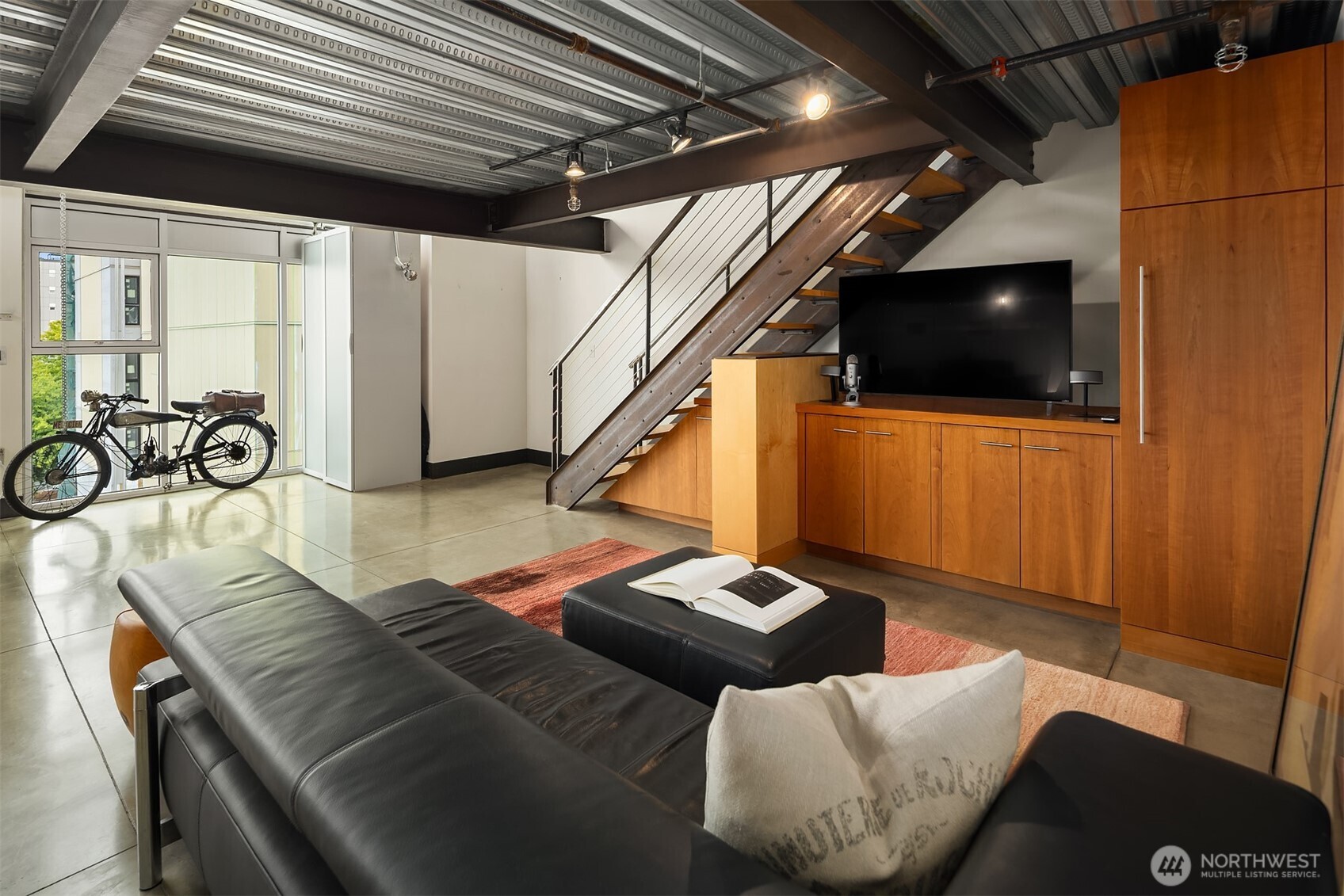 1310 East Union Street, Unit 501 Seattle, WA 98122 - Photo 16 of 30 a living room with furniture and a flat screen tv
