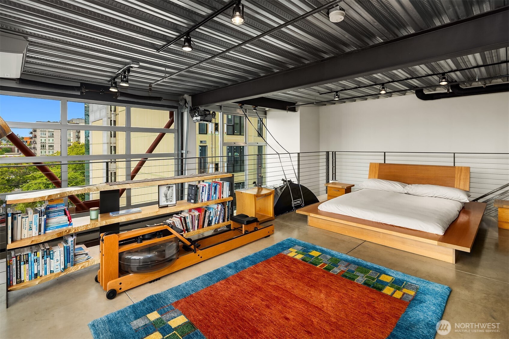 1310 East Union Street, Unit 501 Seattle, WA 98122 - Photo 19 of 30 a room with lots of furniture and a book shelf