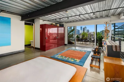 a bedroom with furniture and large windows