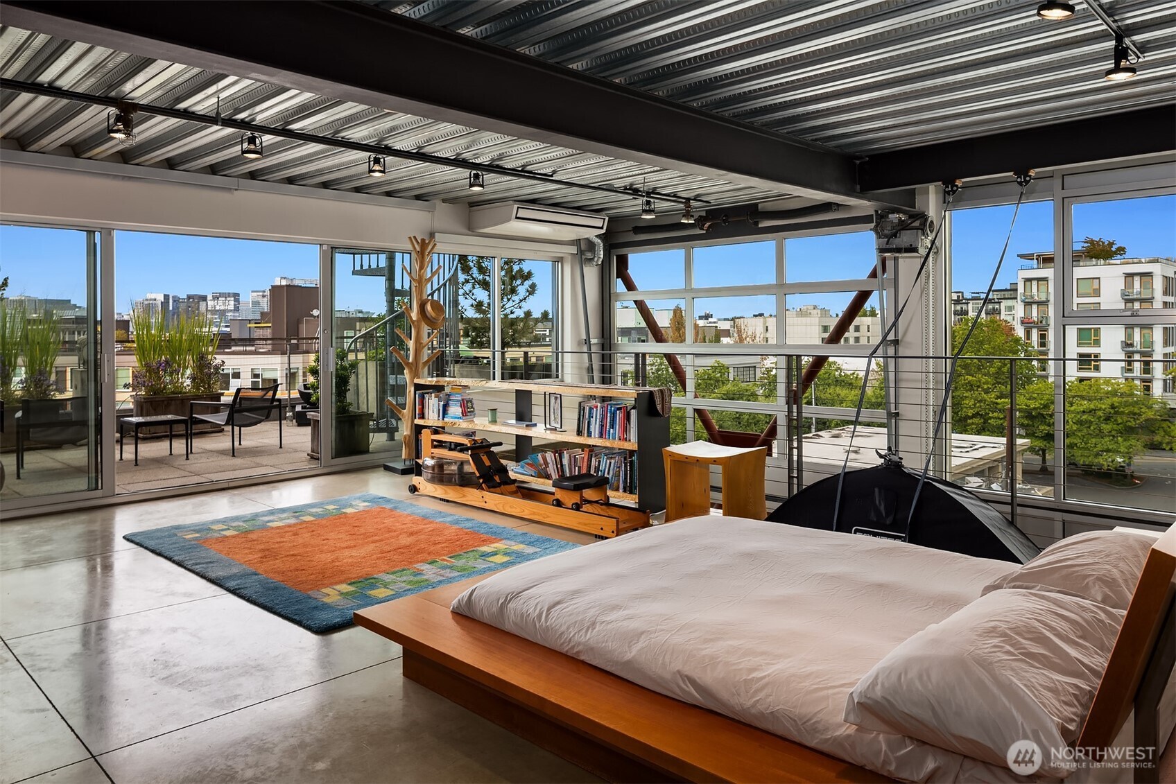 1310 East Union Street, Unit 501 Seattle, WA 98122 - Photo 22 of 30 a bedroom with furniture and large windows