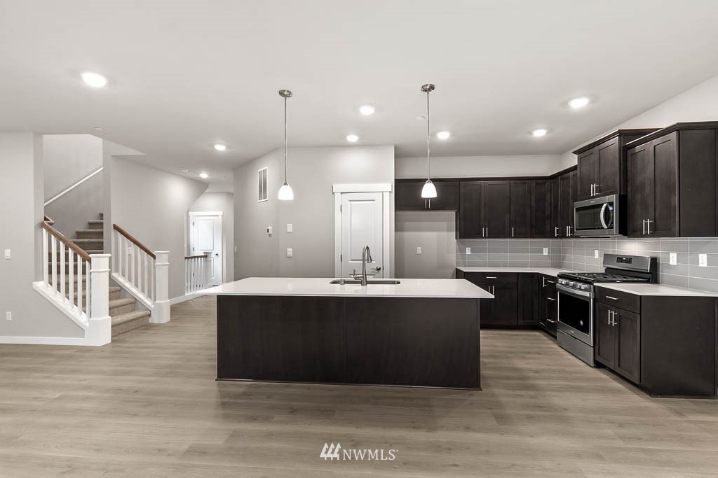 31 211th Street Southeast, Unit P15 Bothell, WA 98021 - Photo 2 of 40 a view of kitchen with stainless steel appliances kitchen island a cabinets and a sink