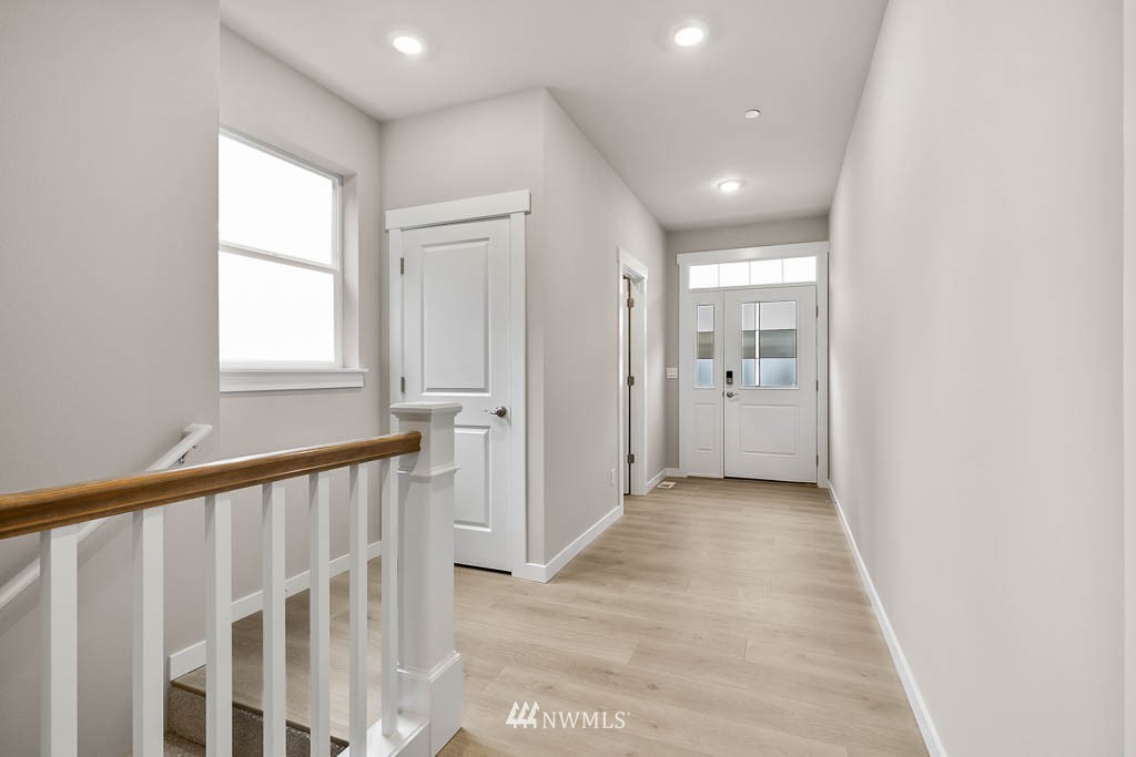 31 211th Street Southeast, Unit P15 Bothell, WA 98021 - Photo 11 of 40 a view of a hallway with a window and a kitchen