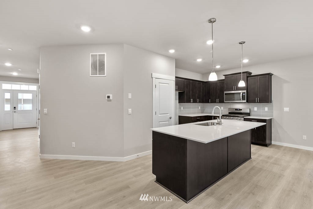 31 211th Street Southeast, Unit P15 Bothell, WA 98021 - Photo 4 of 40 a kitchen with a sink a stove and cabinets