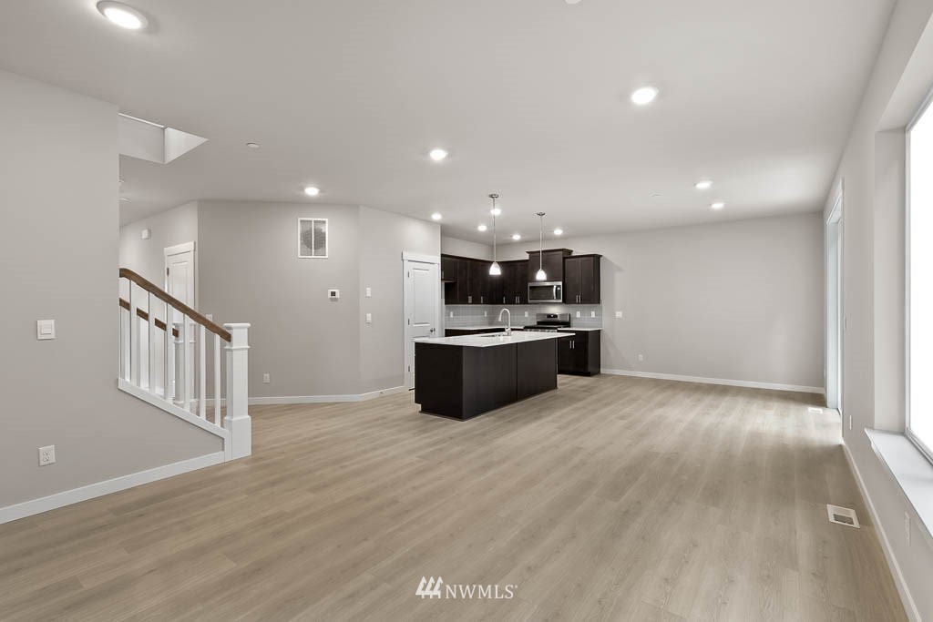 31 211th Street Southeast, Unit P15 Bothell, WA 98021 - Photo 32 of 40 a large kitchen with a sink and dishwasher a stove with wooden floor