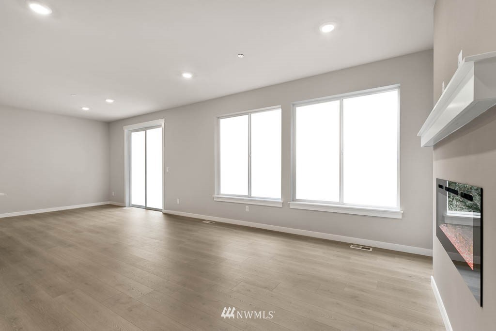 31 211th Street Southeast, Unit P15 Bothell, WA 98021 - Photo 34 of 40 an empty room with wooden floor and windows