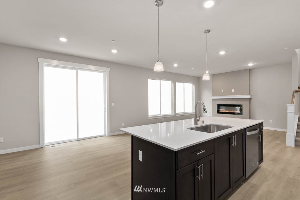 31 211th Street Southeast, Unit P15 Bothell, WA 98021 - Photo 7 of 40 a kitchen with a sink chandelier and wooden floor