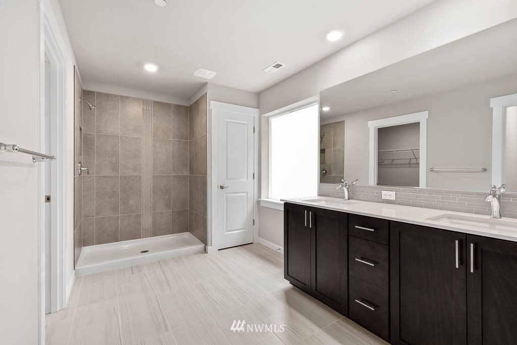 31 211th Street Southeast, Unit P15 Bothell, WA 98021 - Photo 8 of 40 a bathroom with a double vanity sink mirror and shower