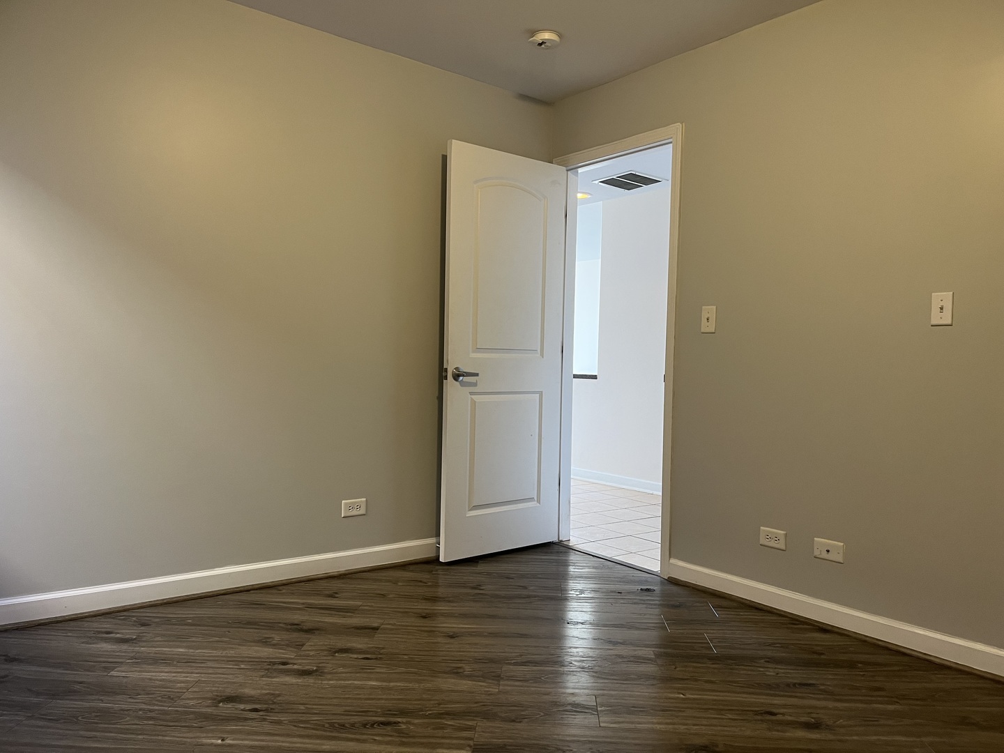 3431 Ridgeland Avenue, Unit 203 Berwyn, IL 60402 - Photo 12 of 18 a view of an empty room with wooden floor and a window