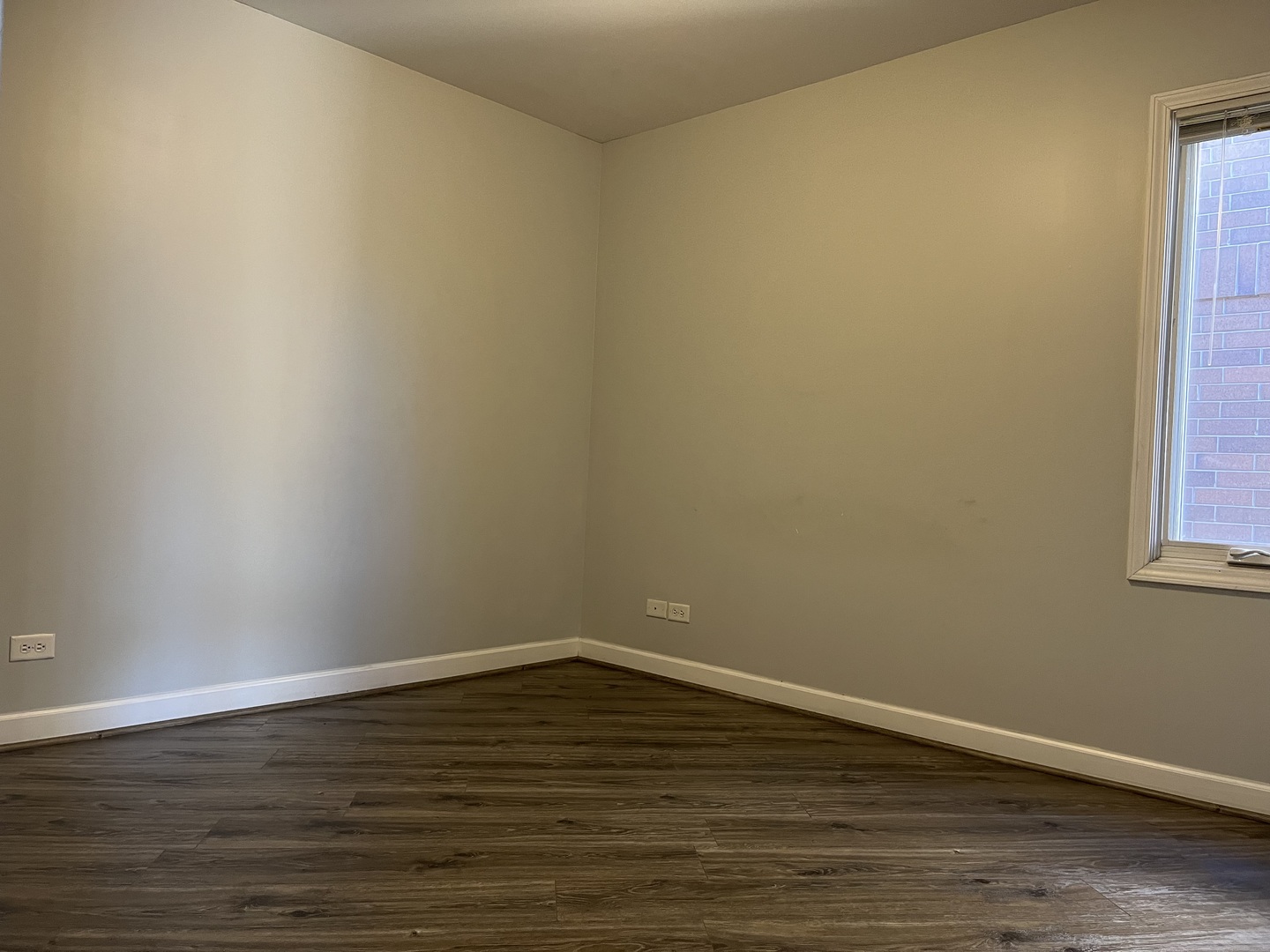 3431 Ridgeland Avenue, Unit 203 Berwyn, IL 60402 - Photo 13 of 18 a view of an empty room with wooden floor and a window