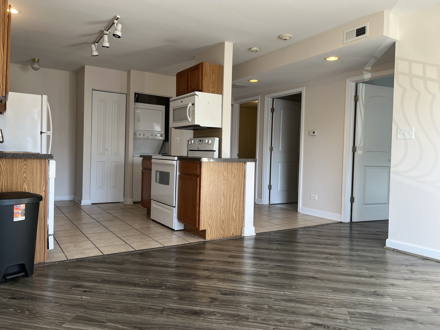 3431 Ridgeland Avenue, Unit 203 Berwyn, IL 60402 - Photo 4 of 18 a view of a kitchen with a refrigerator wooden floor and a kitchen space