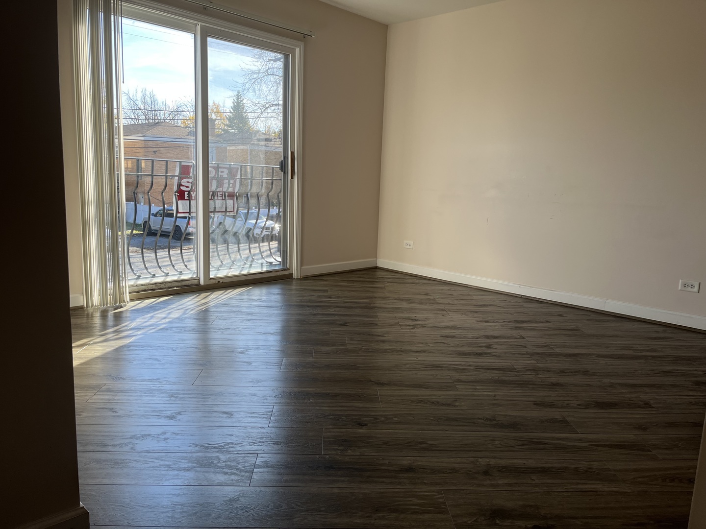 3431 Ridgeland Avenue, Unit 203 Berwyn, IL 60402 - Photo 8 of 18 a view of an empty room with wooden floor and a window