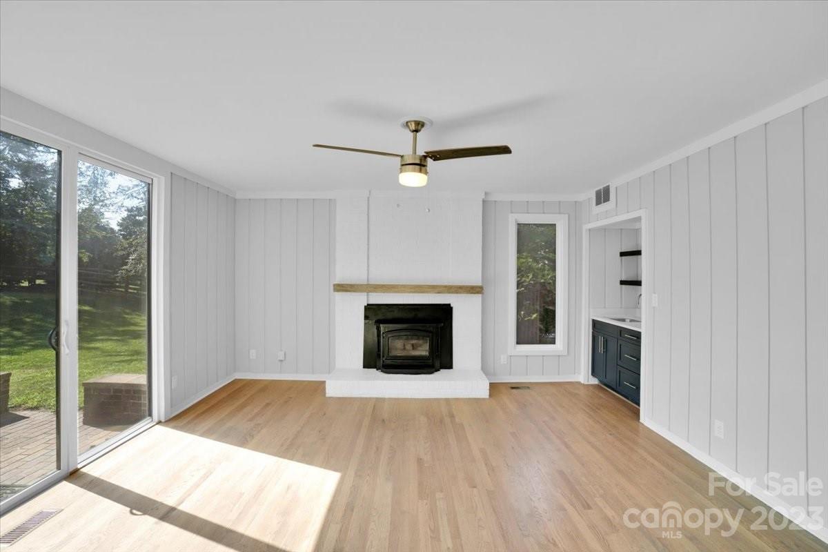 8301 Raintree Lane Charlotte, NC 28277 - Photo 12 of 42 a view of a livingroom with a fireplace a ceiling fan and window