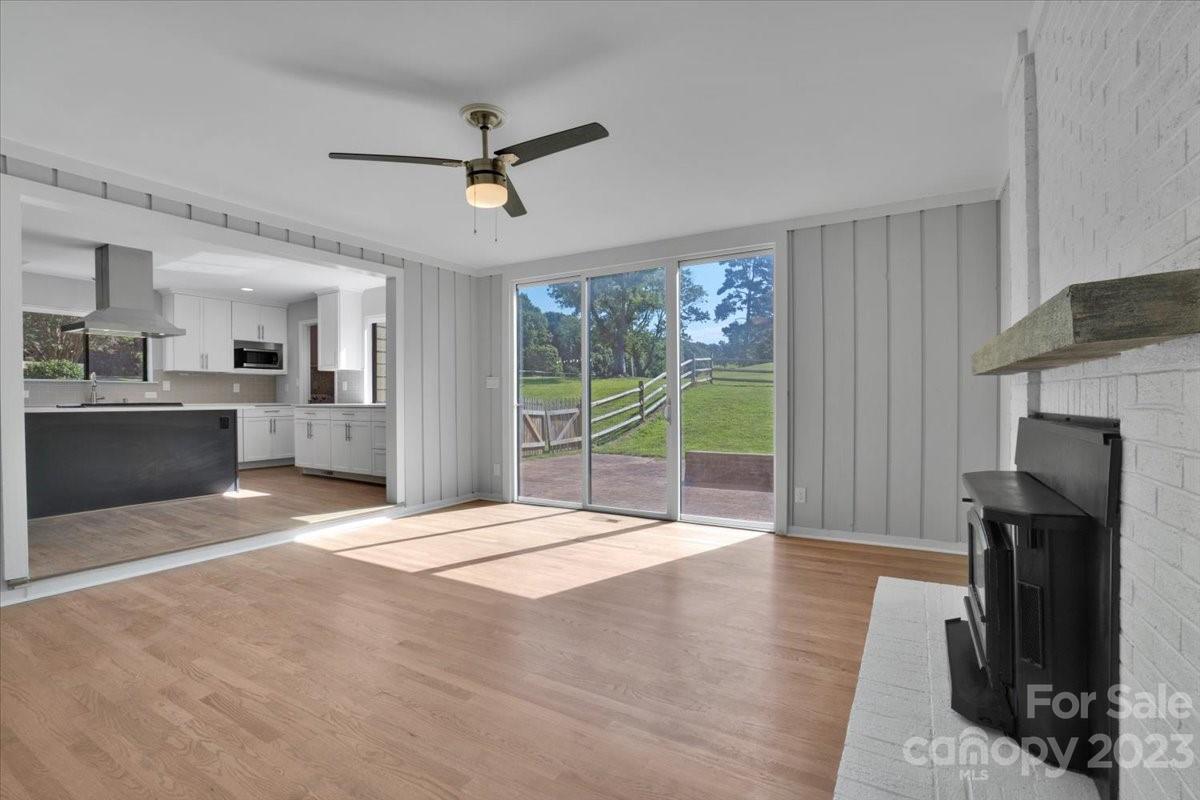 8301 Raintree Lane Charlotte, NC 28277 - Photo 14 of 42 a view of an empty room with a fireplace and a window