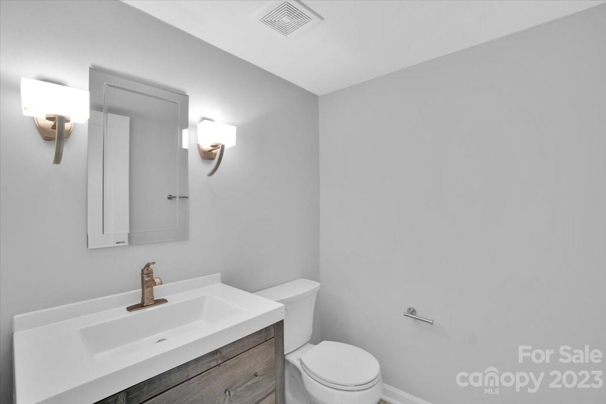 8301 Raintree Lane Charlotte, NC 28277 - Photo 15 of 42 a bathroom with a sink a toilet and mirror