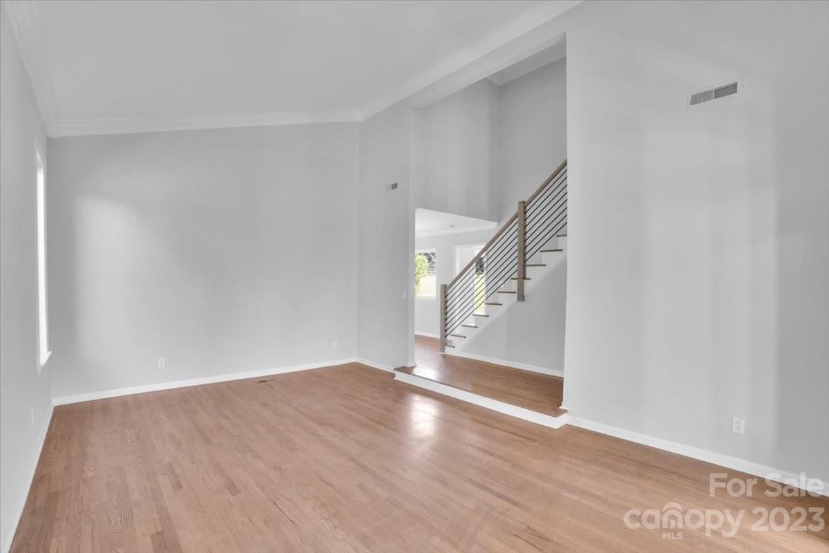 8301 Raintree Lane Charlotte, NC 28277 - Photo 16 of 42 a view of an empty room with wooden floor and stairs
