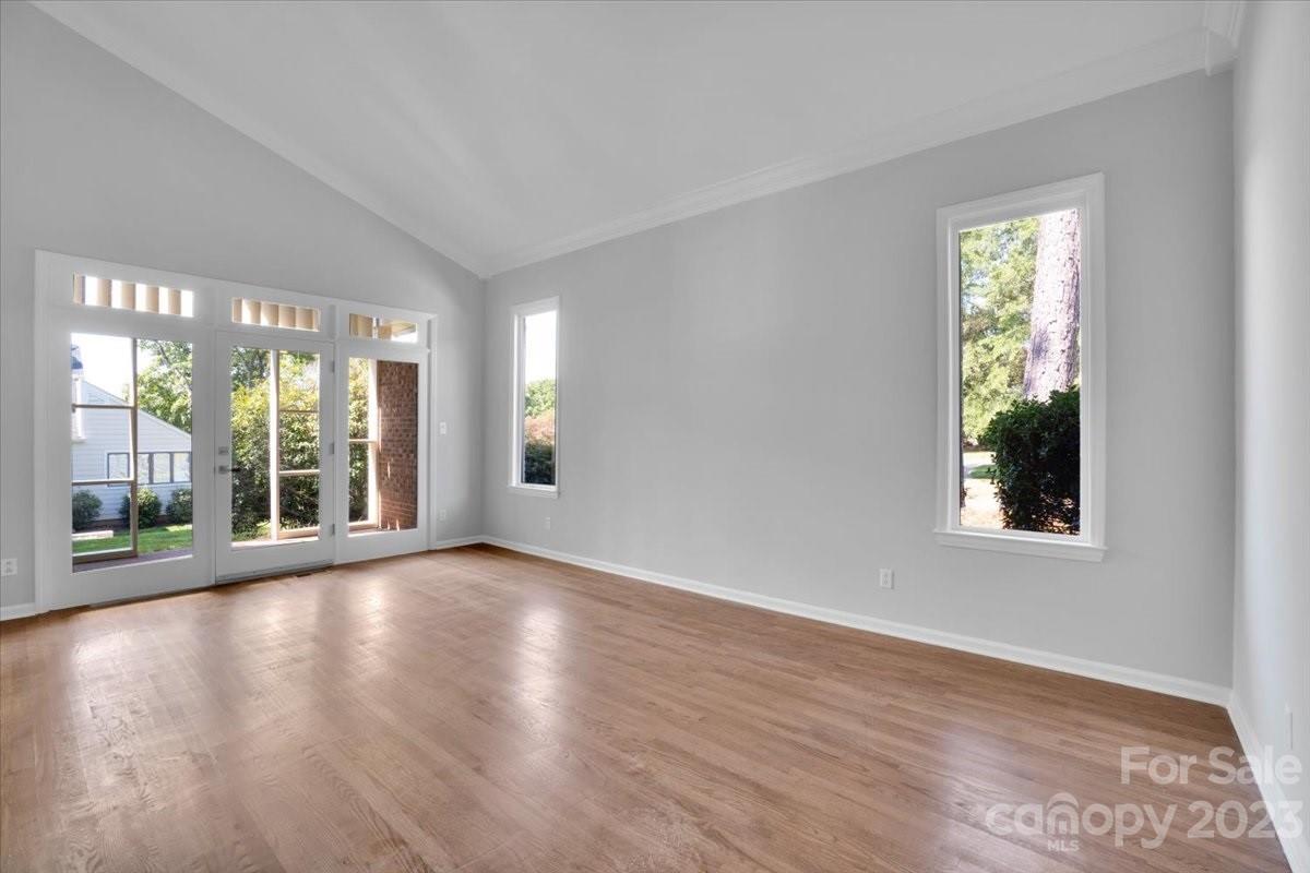 8301 Raintree Lane Charlotte, NC 28277 - Photo 17 of 42 a view of an empty room with wooden floor and a window