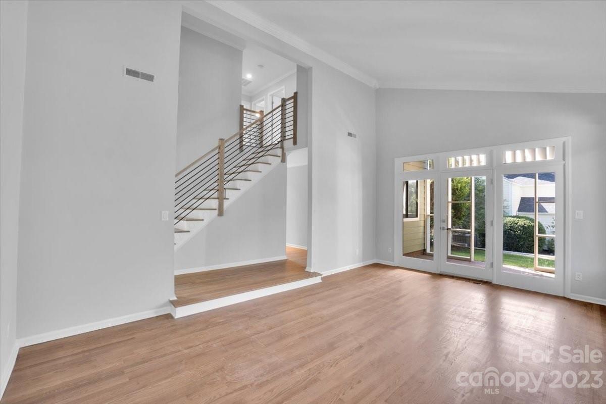 8301 Raintree Lane Charlotte, NC 28277 - Photo 18 of 42 an empty room with wooden floor and windows
