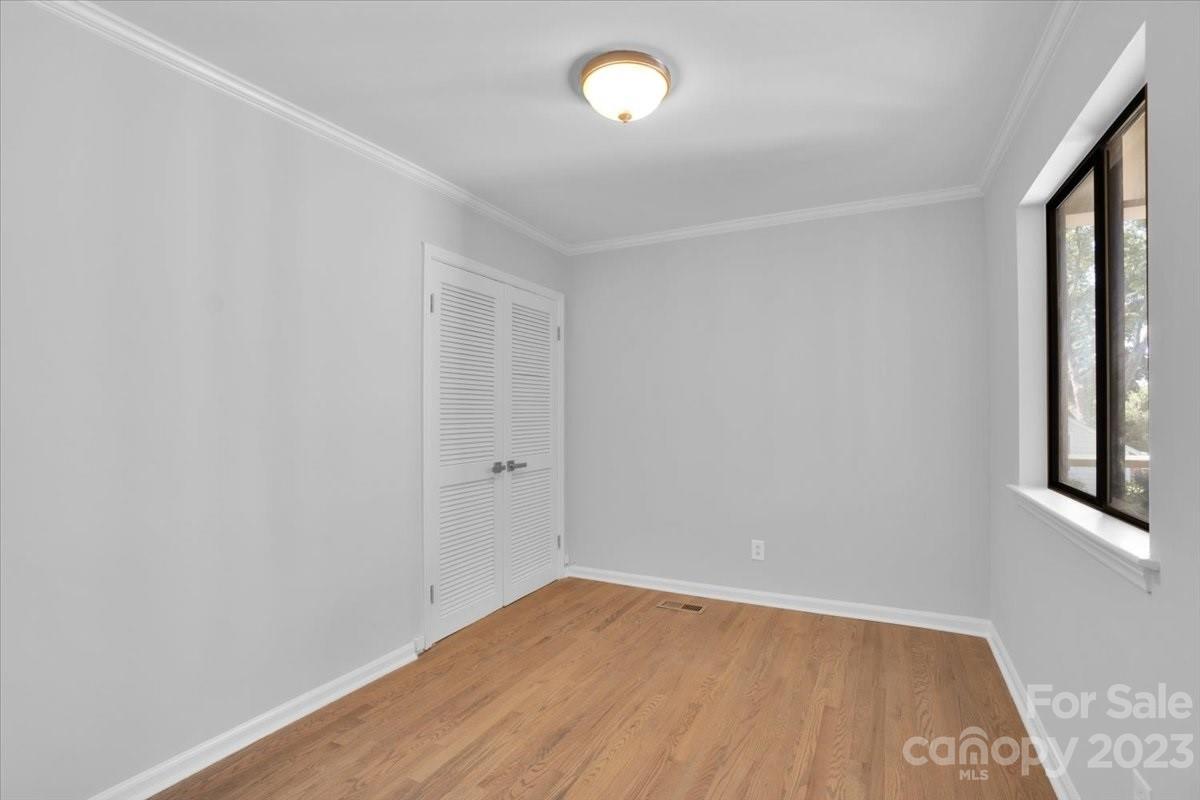 8301 Raintree Lane Charlotte, NC 28277 - Photo 21 of 42 a view of an empty room with wooden floor and a window
