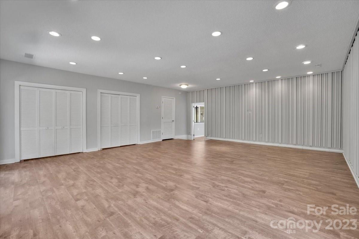 8301 Raintree Lane Charlotte, NC 28277 - Photo 22 of 42 a view of an empty room with wooden floor