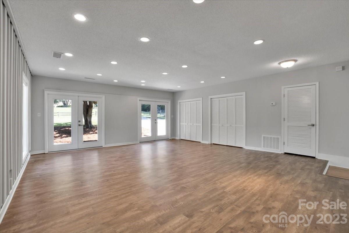 8301 Raintree Lane Charlotte, NC 28277 - Photo 23 of 42 a view of an empty room with wooden floor and a window