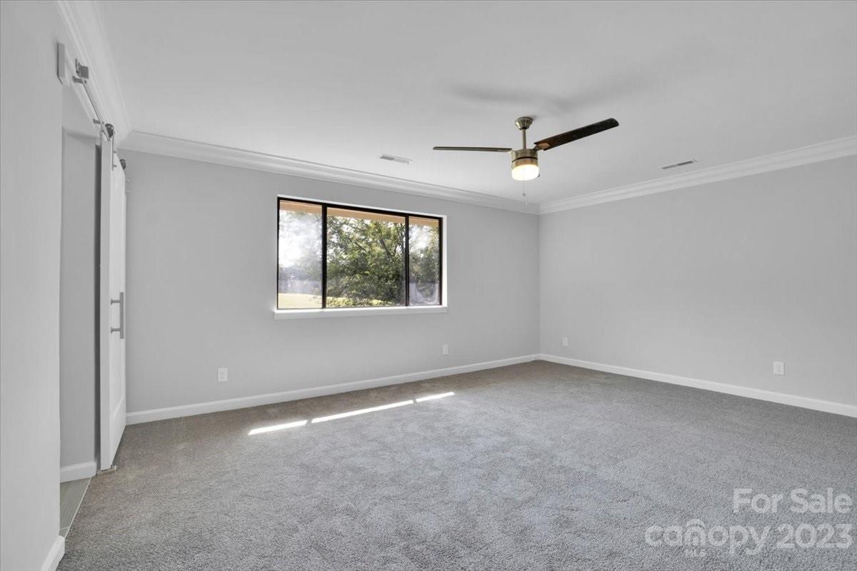 8301 Raintree Lane Charlotte, NC 28277 - Photo 26 of 42 an empty room with a window and a ceiling fan