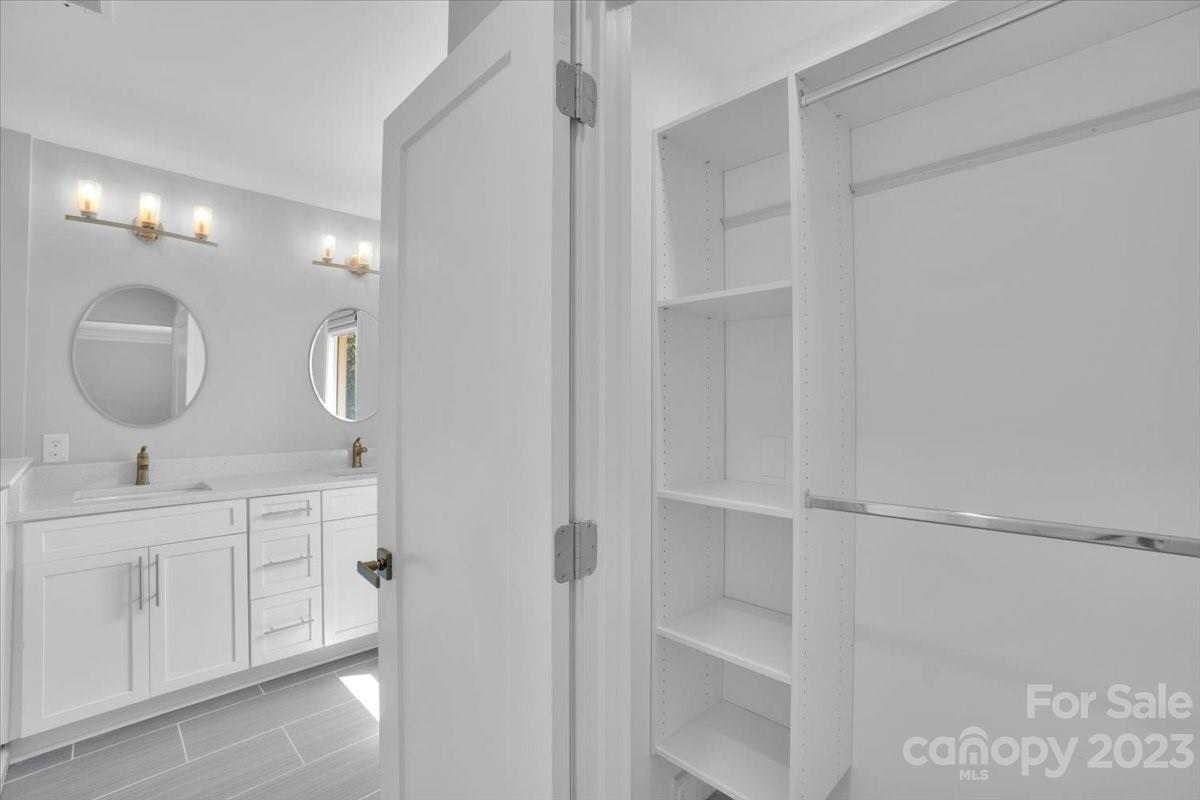 8301 Raintree Lane Charlotte, NC 28277 - Photo 28 of 42 a bathroom with a double vanity sink and a mirror