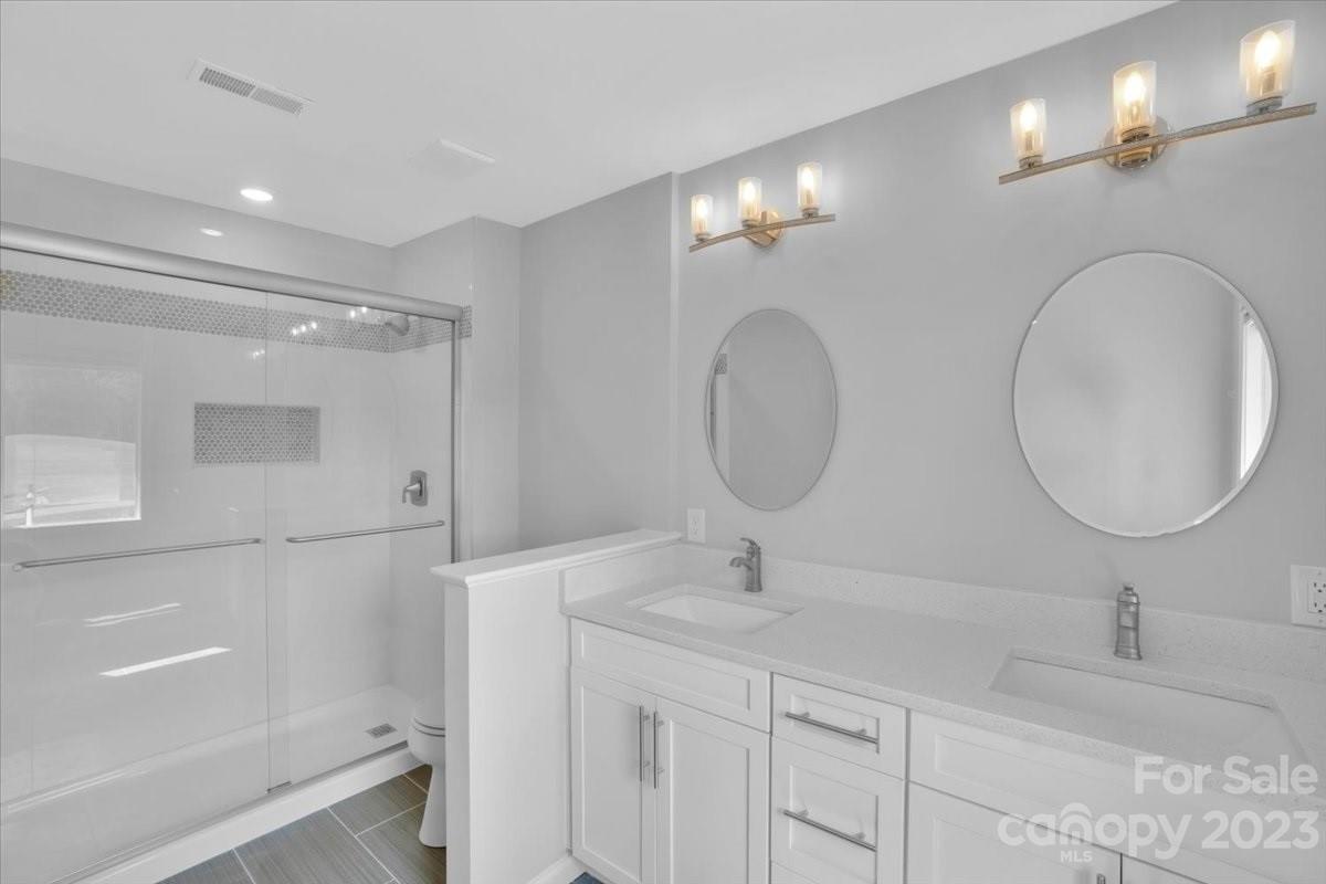 8301 Raintree Lane Charlotte, NC 28277 - Photo 29 of 42 a bathroom with a double vanity sink and a mirror