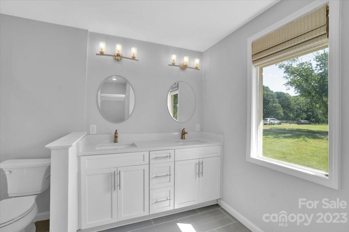 8301 Raintree Lane Charlotte, NC 28277 - Photo 30 of 42 a bathroom with a double vanity sink and a mirror
