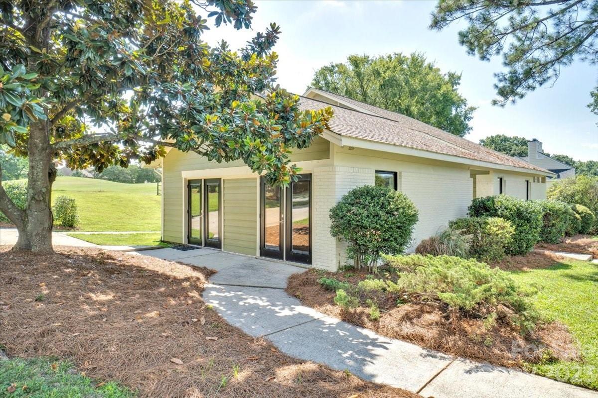 8301 Raintree Lane Charlotte, NC 28277 - Photo 37 of 42 a front view of a house with garden