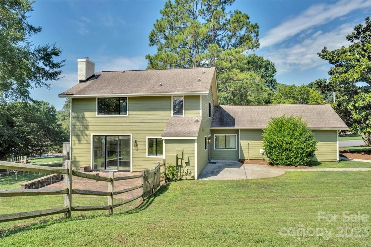 8301 Raintree Lane Charlotte, NC 28277 - Photo 38 of 42 a white house with a yard and a large tree