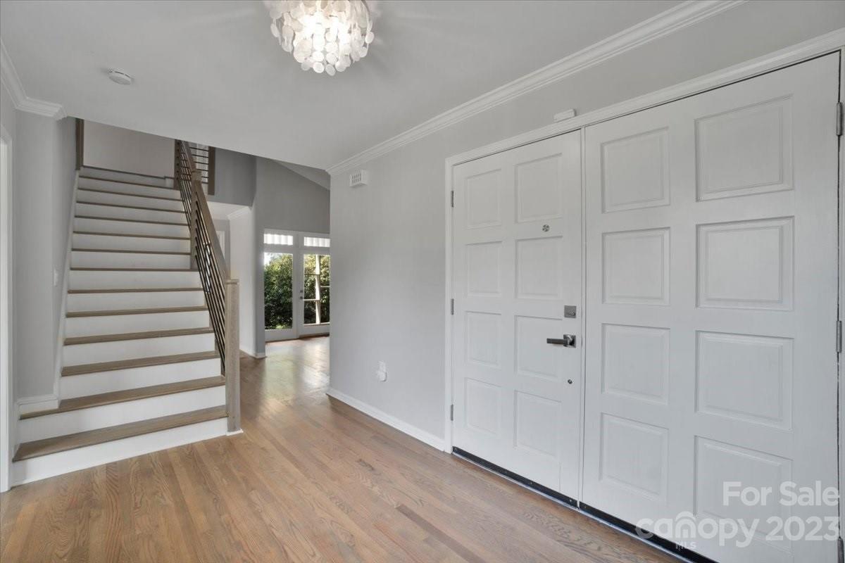 8301 Raintree Lane Charlotte, NC 28277 - Photo 4 of 42 a view of a hallway with wooden floor and staircase