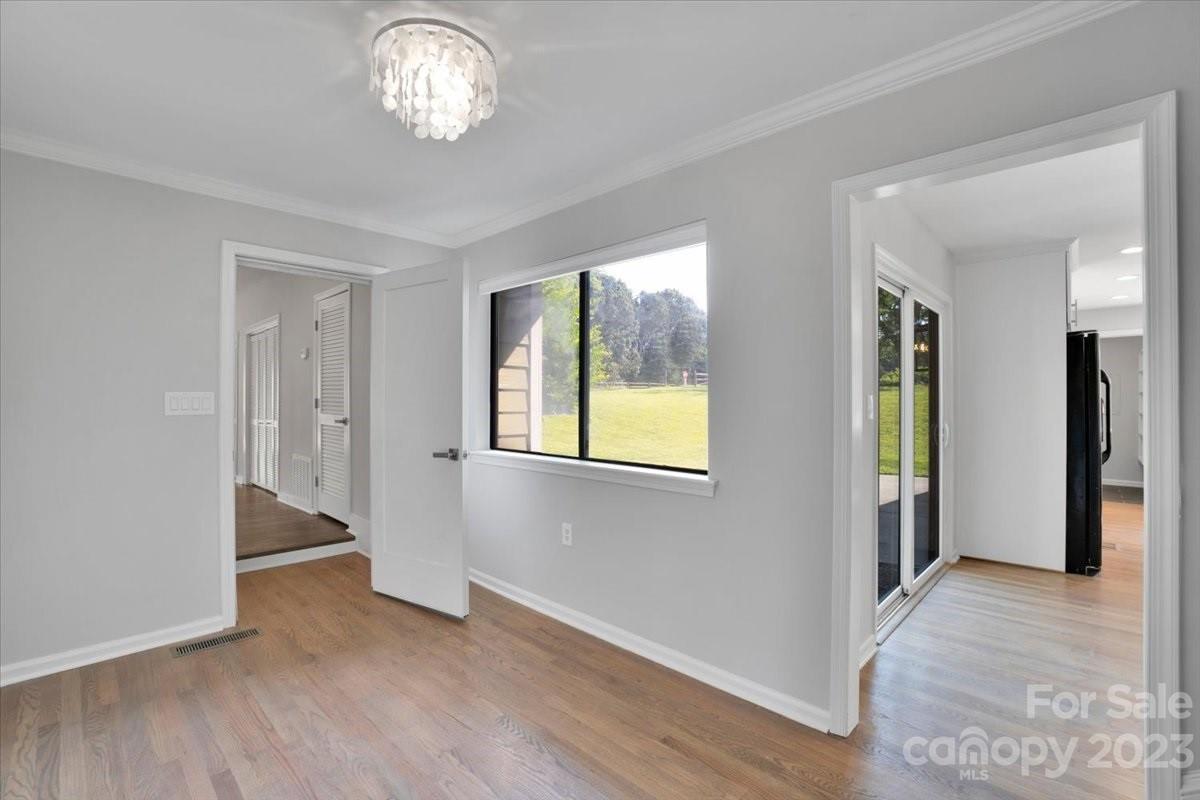 8301 Raintree Lane Charlotte, NC 28277 - Photo 5 of 42 a view of an empty room with a window and wooden floor