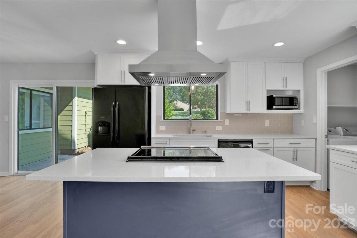 8301 Raintree Lane Charlotte, NC 28277 - Photo 8 of 42 a kitchen with kitchen island a sink refrigerator and window