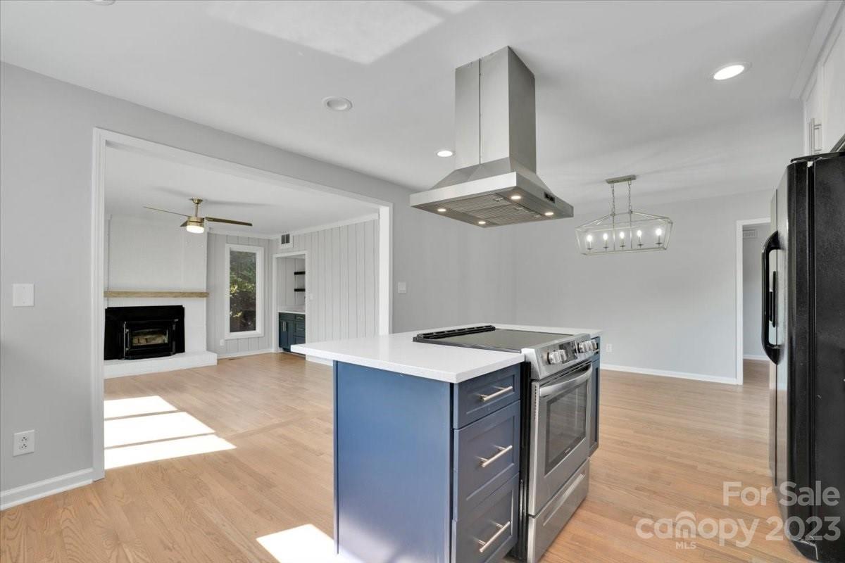 8301 Raintree Lane Charlotte, NC 28277 - Photo 9 of 42 a kitchen with a stove a refrigerator and a fireplace