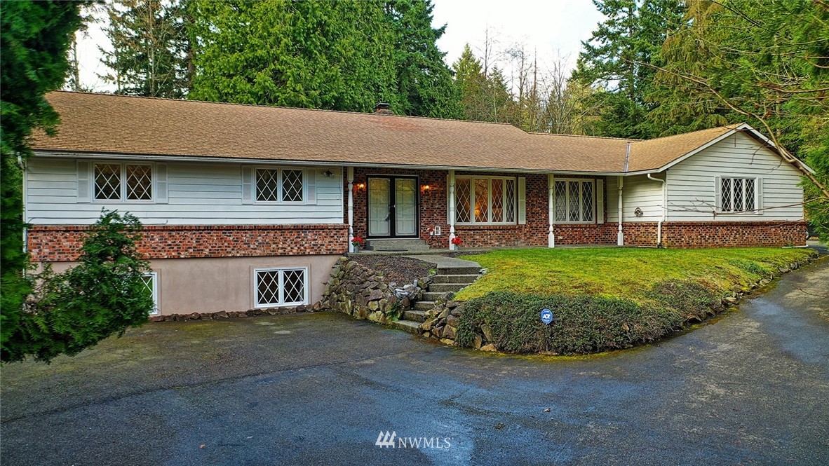 5011 228th Street Southeast Bothell, WA 98021 - Photo 1 of 40 a front view of a house with garden