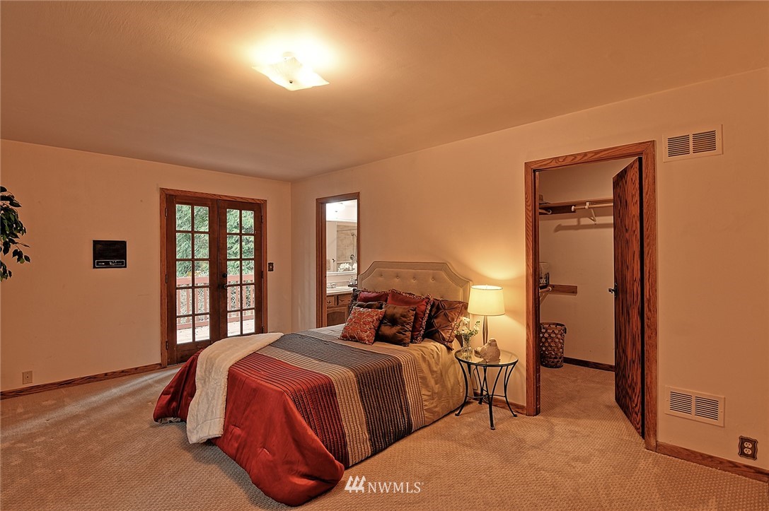 5011 228th Street Southeast Bothell, WA 98021 - Photo 11 of 40 a bedroom with a bed and a window