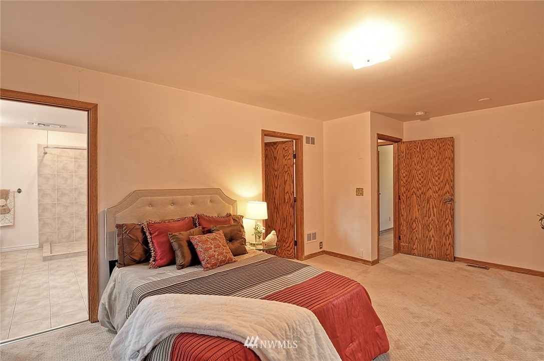 5011 228th Street Southeast Bothell, WA 98021 - Photo 12 of 40 a bedroom with a bed and a mirror