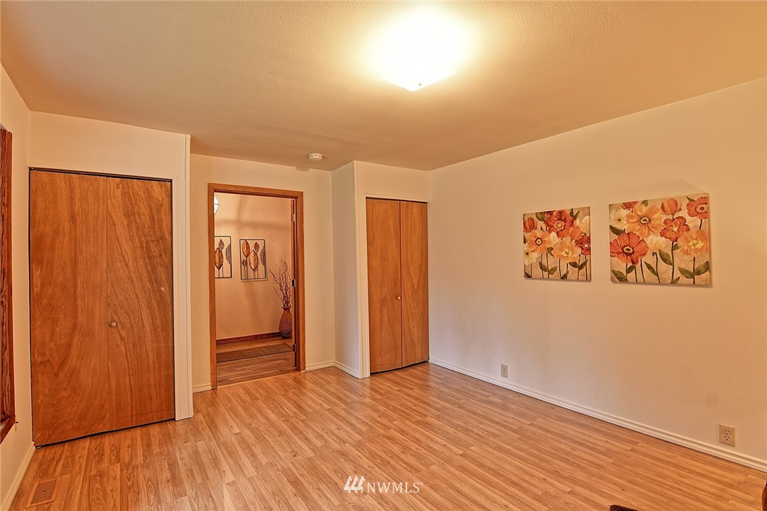 5011 228th Street Southeast Bothell, WA 98021 - Photo 15 of 40 an empty room with wooden floor and closet