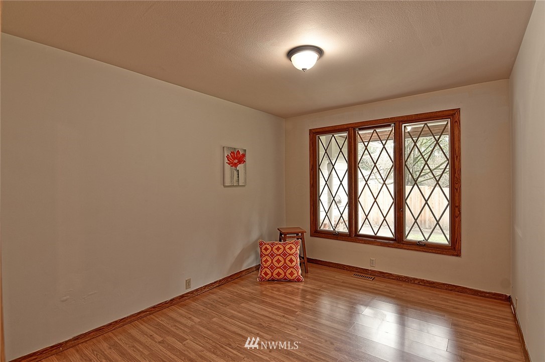 5011 228th Street Southeast Bothell, WA 98021 - Photo 16 of 40 an empty room with wooden floor and windows