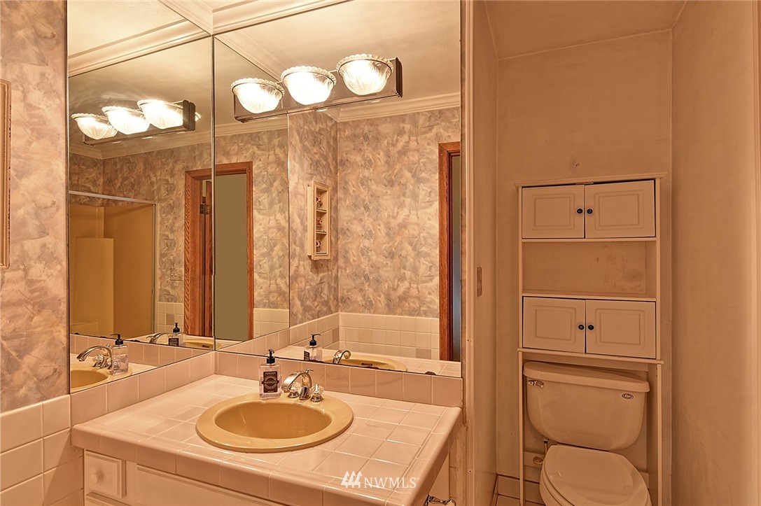 5011 228th Street Southeast Bothell, WA 98021 - Photo 18 of 40 a bathroom with a sink vanity granite tub and a mirror