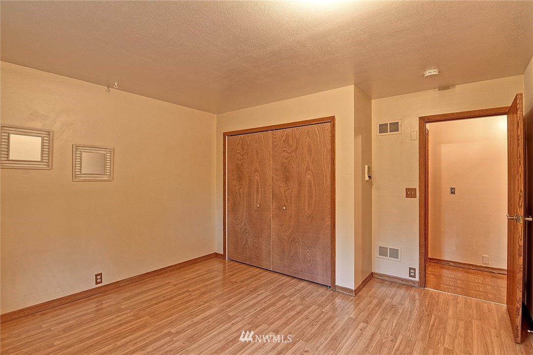 5011 228th Street Southeast Bothell, WA 98021 - Photo 19 of 40 a view of an empty room with wooden floor and a window