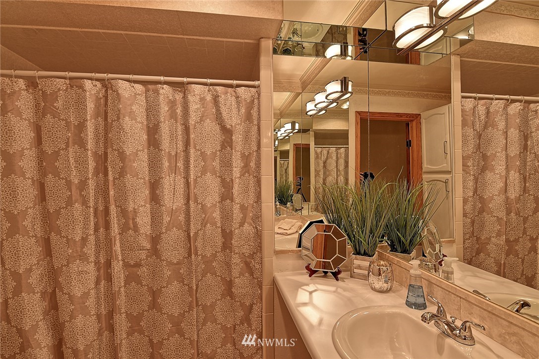 5011 228th Street Southeast Bothell, WA 98021 - Photo 20 of 40 a bathroom with a sink and a mirror