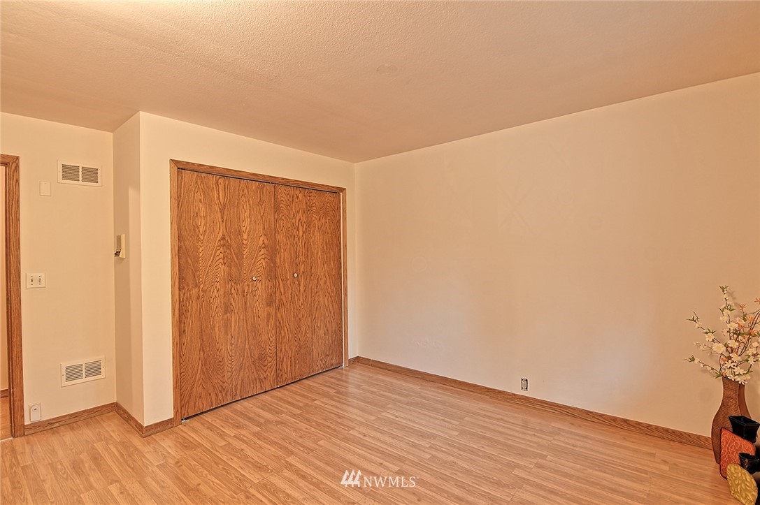 5011 228th Street Southeast Bothell, WA 98021 - Photo 21 of 40 a view of an empty room with wooden floor
