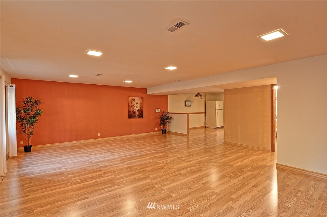 5011 228th Street Southeast Bothell, WA 98021 - Photo 23 of 40 a view of an empty room with wooden floor
