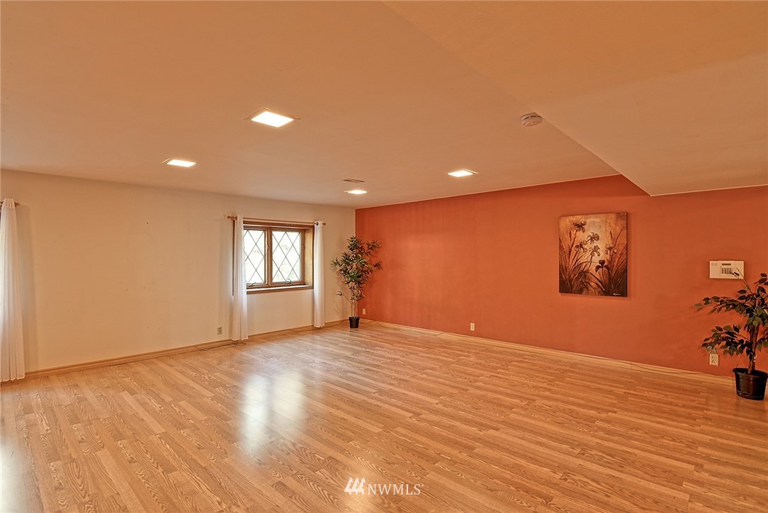 5011 228th Street Southeast Bothell, WA 98021 - Photo 24 of 40 a view of an empty room with window and wooden floor