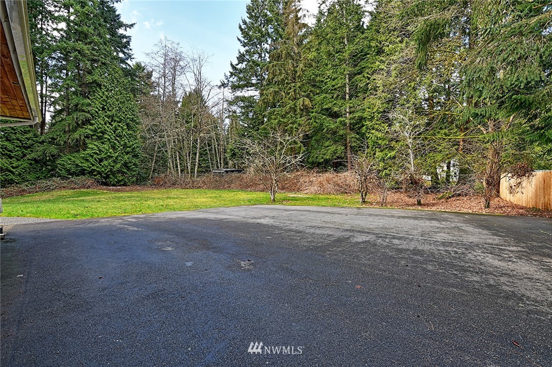 5011 228th Street Southeast Bothell, WA 98021 - Photo 37 of 40 a view of a house with a yard and a large tree