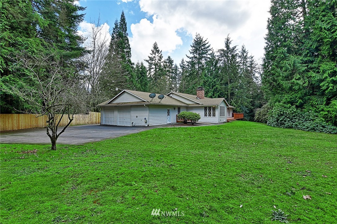 5011 228th Street Southeast Bothell, WA 98021 - Photo 38 of 40 a view of a house with backyard and a tree