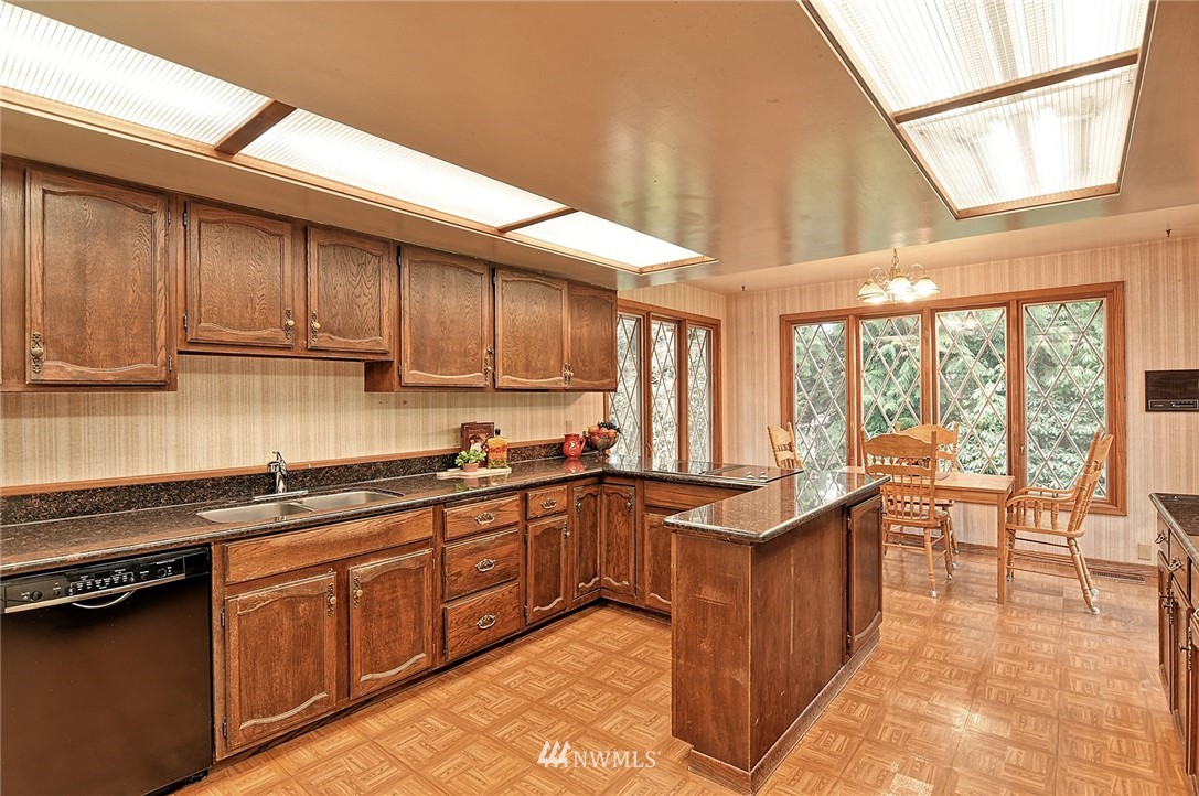 5011 228th Street Southeast Bothell, WA 98021 - Photo 7 of 40 a kitchen with stainless steel appliances granite countertop a stove a sink and a microwave