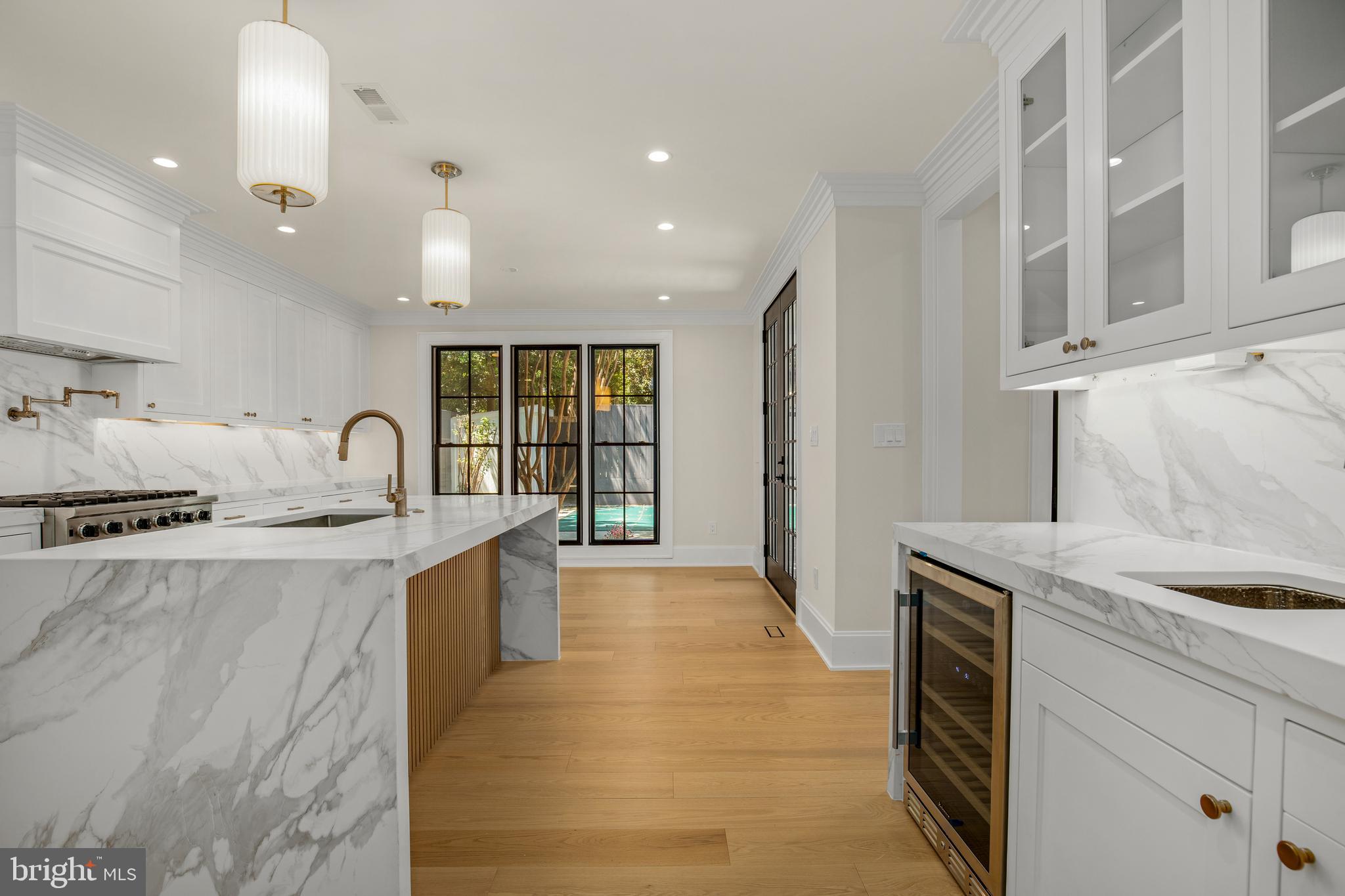 2710 36th Street Northwest Washington, DC 20007 - Photo 12 of 29 a large kitchen with stainless steel appliances granite countertop a sink and dishwasher a stove with wooden floors