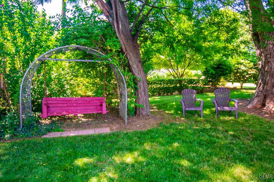 2121 7th Street Bethlehem, PA 18020 - Photo 13 of 14 a view of a backyard with table and chairs with a fire pit and large trees